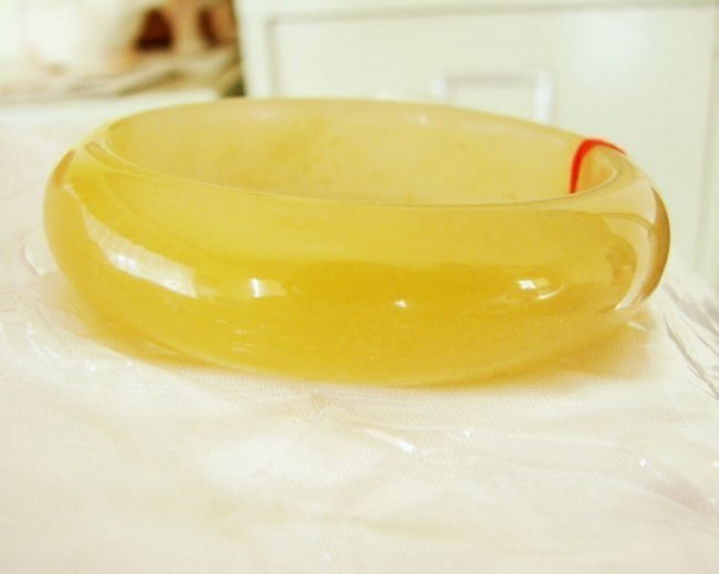 Natural Jadeite Jade Bangle JBA-2B Size 8: Natural Jadeite Jade Bangle Clarity: JBA-2B, Color: Golden and Creamery White Transparency: Semi -Transparent Shape & Cut: Solid Jade Band Haft Round Jade Finish: High Polish Remarks: Genuine Jadeite 