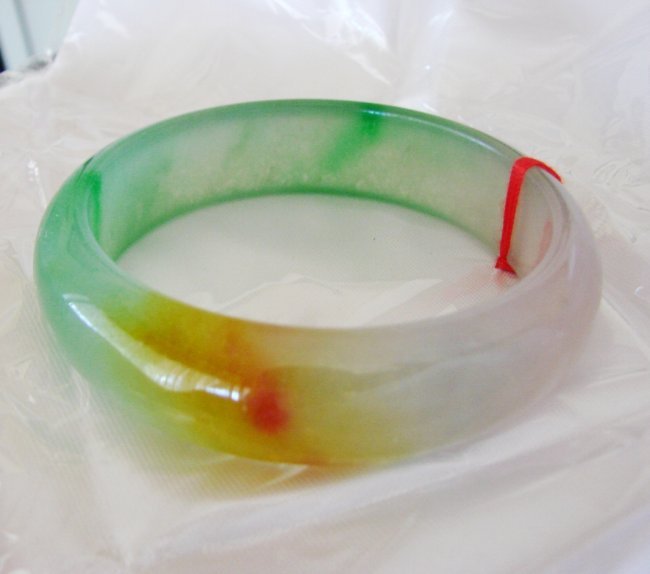 Natural Jadeite Jade Bangle JBA-1B Size 7: Natural Jadeite Jade Bangle Clarity: JBA-1B, Color: Multicolor Transparency: Semi -Transparent Shape & Cut: Solid Jade Band Haft Round Jade Finish: High Polish Remarks: Genuine Jadeite Quality: Excell