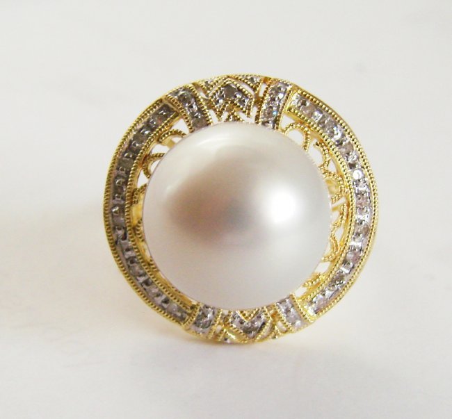 13.2mm South Sea Pearl-Diamond Ring .25Ct 14k Y/g: Gem Type: Natural Golden South Sea Pearl and Diamonds Item: Ring Diamonds 34 Pieces Weight: .91 Carat Round Brilliant (Clarity: VS2-SI1 ,Color :G, Treatment: None) Diamonds Baguette 12 Pieces (Clarity