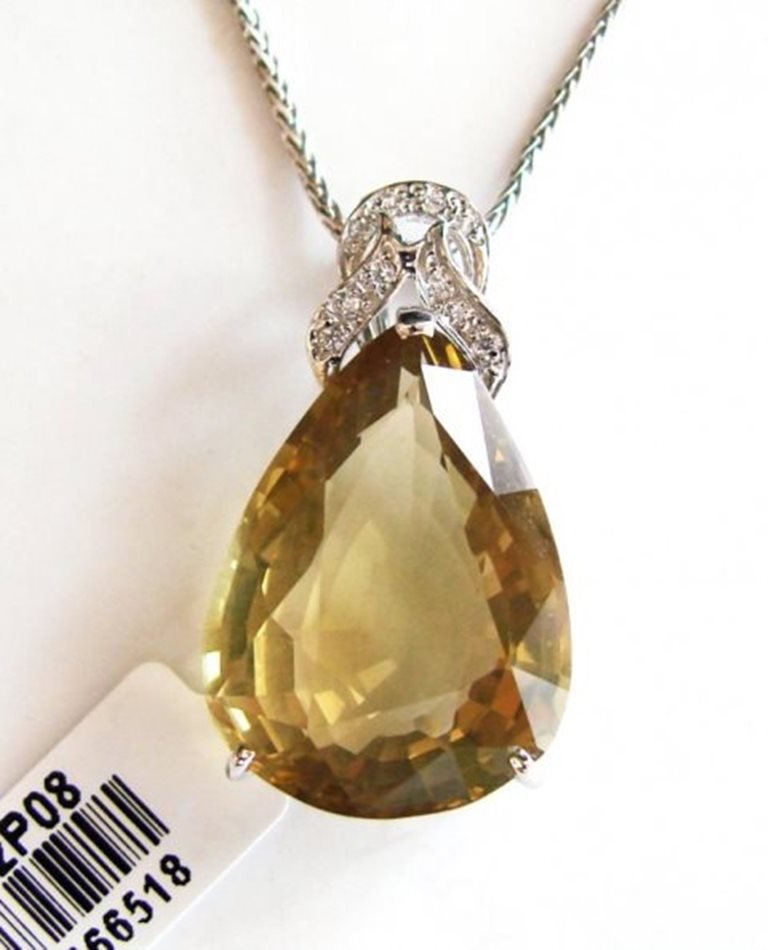 Lemon Topaz Pendant 17.56Ct 18k W/g Overlay: Gem Type: Natural Lemon Topaz/Creation Diamond Quantity: 1 Lemon Topaz: Approx 17.56 Carat (Pear Shaped, Cut: Facet, Size: 14x8x6mm) Clarity: VS1, Color: Medium Yellow, Treatment: None Hardness 7 Orig