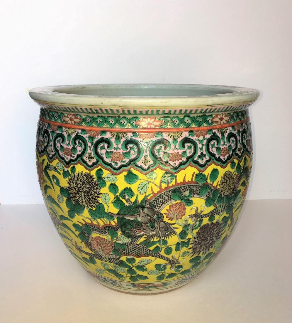 A Chinse Famille Verte Dragon Jardiniere (Fish Bowl): 19th Century, imperial yellow ground enameled with two dragons surrounding by flowers; 16 in. (40.5 cm) diameter 黄地龙纹鱼缸