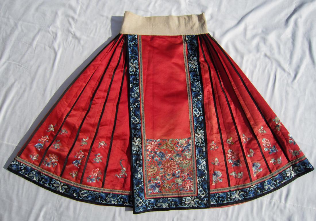 A Chinese Red Silk Skirt with Imperial Stitch Flower: late Qing dynasty, good condition to its age; 38 in. (97 cm) long 清代打籽绣女裙
