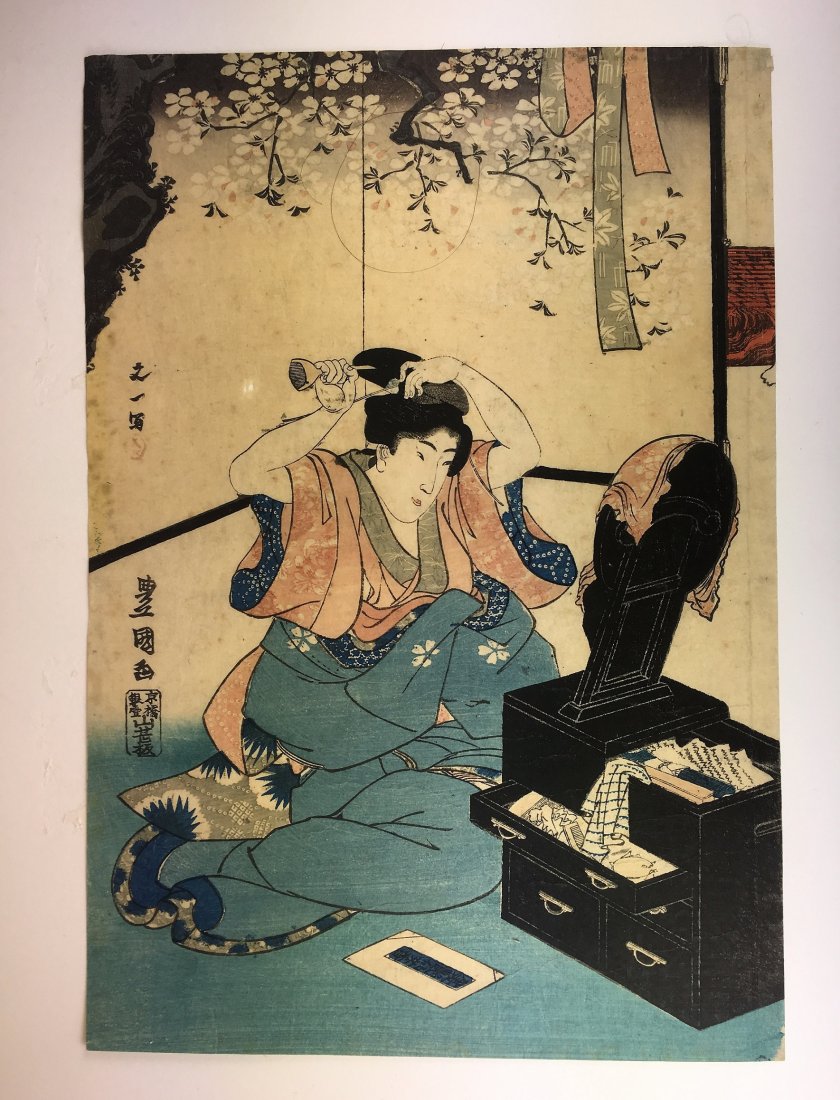 A Japanese Woodblock Print by Utagawa Toyokuni: Meiji period, depicting a beauty looking at mirror, good color and impression, trimmed margin; 14 1/4 x 9 7/8 in. (36.3 cm x 25 cm)