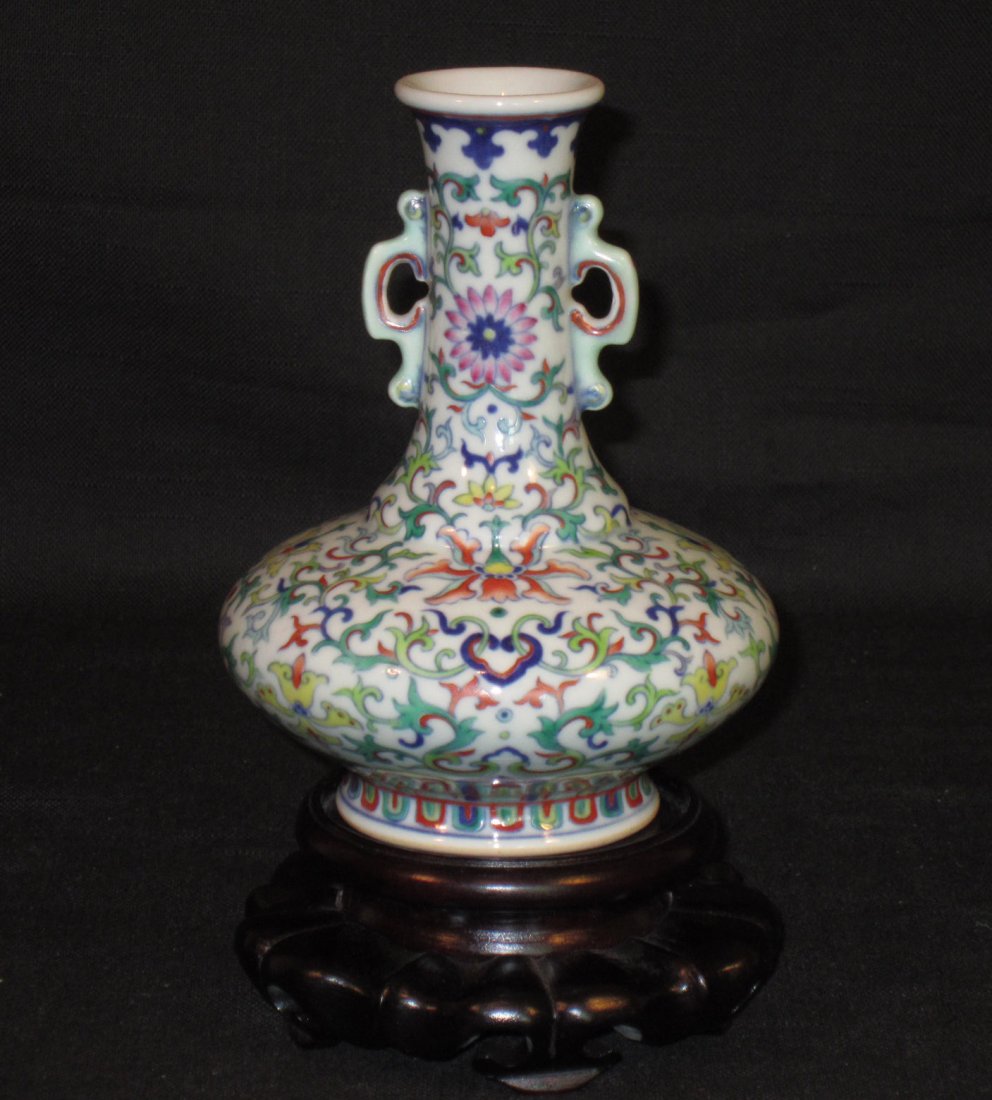 A Small Chinese Dou Cai Vase, Qianlong Mark: A Small Chinese Dou Cai Vase with lotus flowers decoration and two Ruyi form handles, Apocryphal Qianlong Seal Mark, very fine work done by a skillful craftsman; puchased from Leslie Hindman Auction i