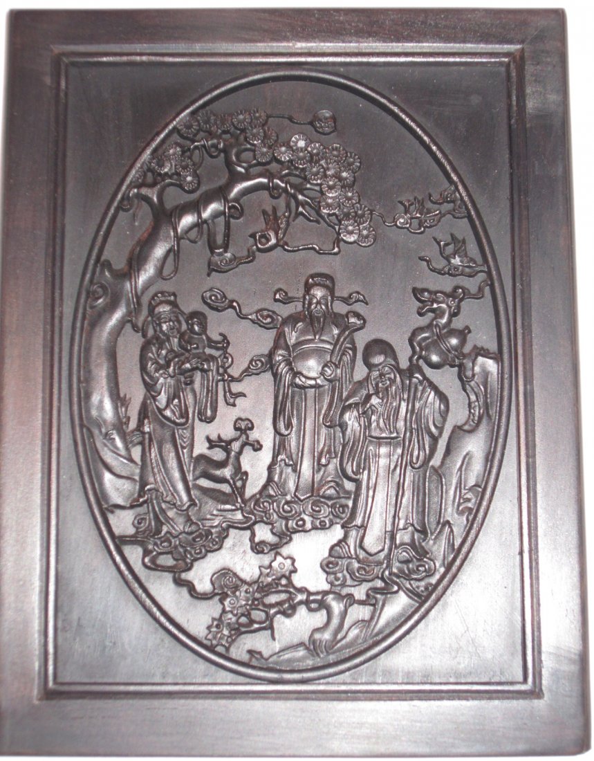 A Chinese Carved Zitan Wood Plaque: 20th Century, depicting three immortals Fu, Lu, and Shou on one side and bats on another. Length 6.5" (17cm) x Width 5" (12.5cm). No stand.