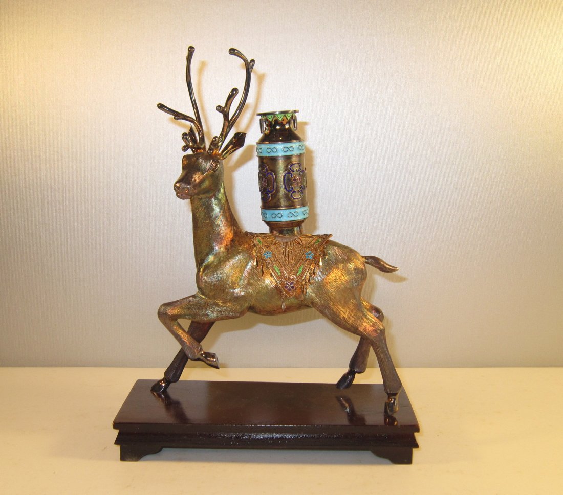 A Chinese Gilded and Enameled Silver Deer with Vase: middle of 20th Century, mounted on wood stand, stamped 925. Overall 9 in. (22.5 cm) high, 6 in. (15cm) wide 银烧蓝镀金仙鹿瓶