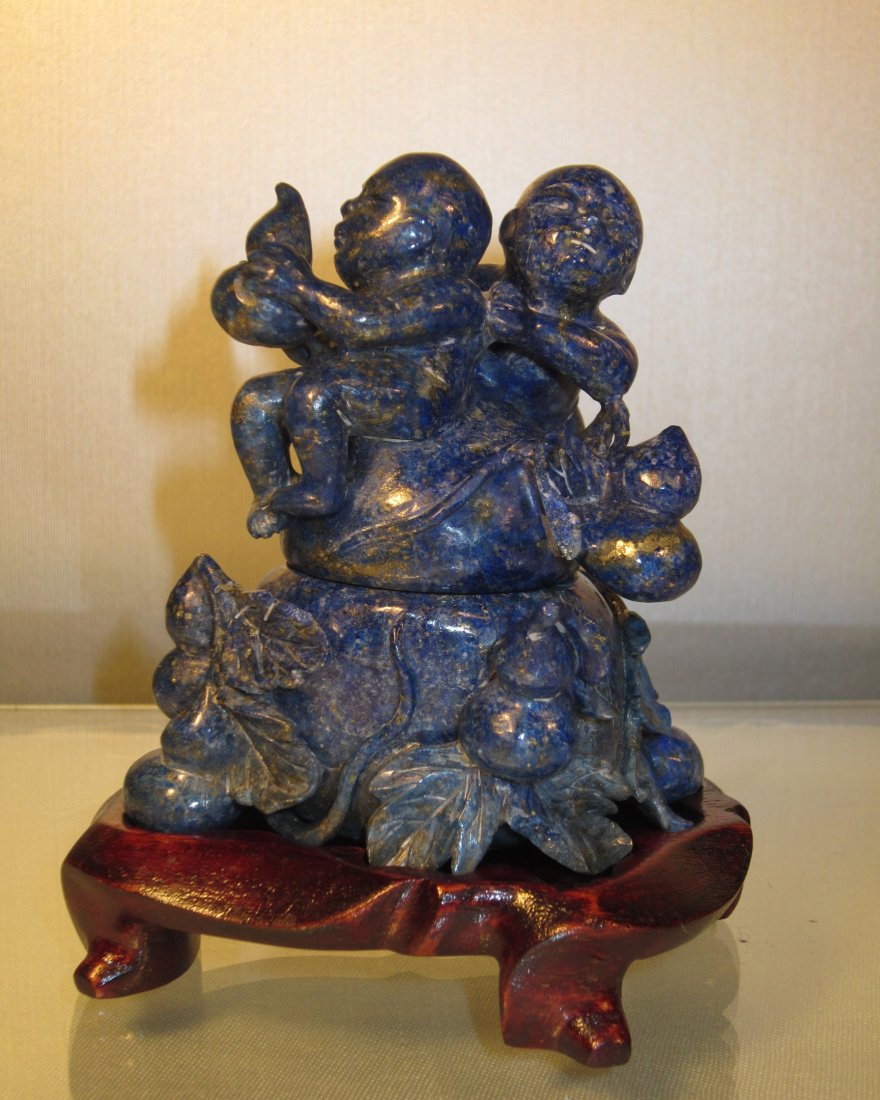 A Chinese Carved Lapis Ink Well and Cover: circa late Qing, cover carved with two boys, body carved as guard form; stone only 3.4 in. (8.4 cm) high, 3 in. (7.5 cm) wide 青金石带盖小水丞