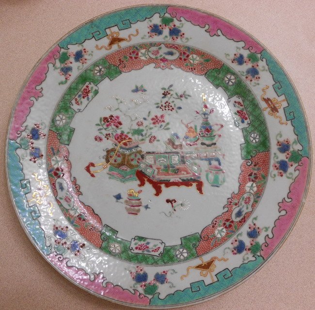 Chinese export charger: A Chinese famille rose charger. Decorated with flowers, antiques,vases. D:11" (27.8cm) Shipping within Canada & continental U.S.A. $50. Shipping to China $70. All other countries, please Email for shi