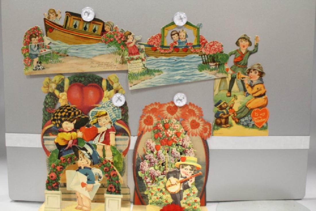 Lot of 5 Large Mechanical / Fold Out Valentines: 1920s - two are fold-outs, banjo playing boy and "mailman", largest 9 3/4" H; 3 mechanical, Germany campers / scouts, and house boat and boat. Note: These Valentines are from two estates, one was a co