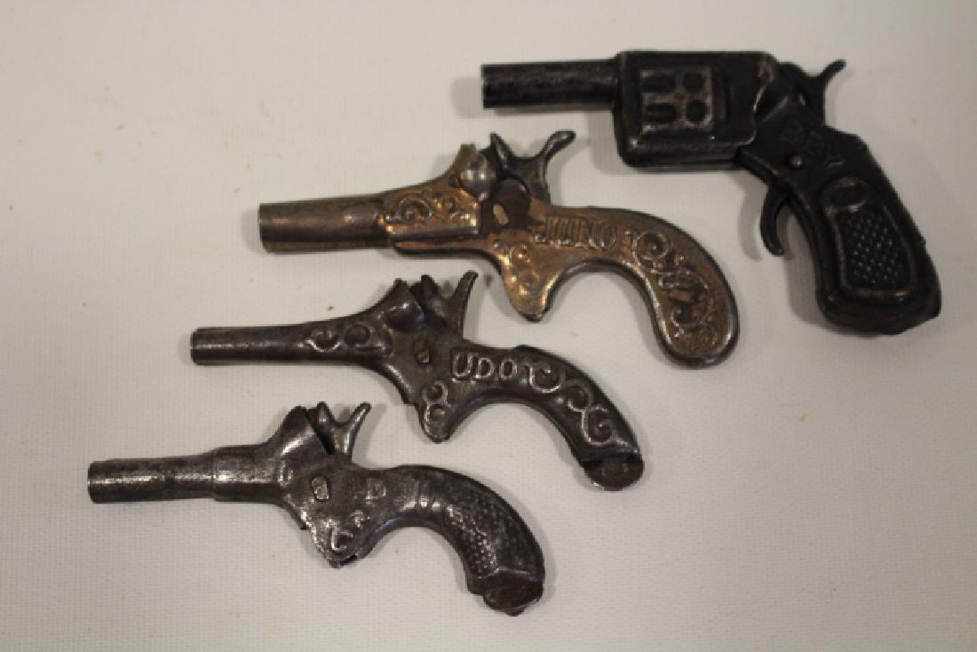19th C Single Shot Miniature Tin Cap Guns: 19th century single shot miniature tin cap guns - Bey D.R.R., 3" L; "D", 3" L; Juno, 3" L; UDO 3" L, - all working.