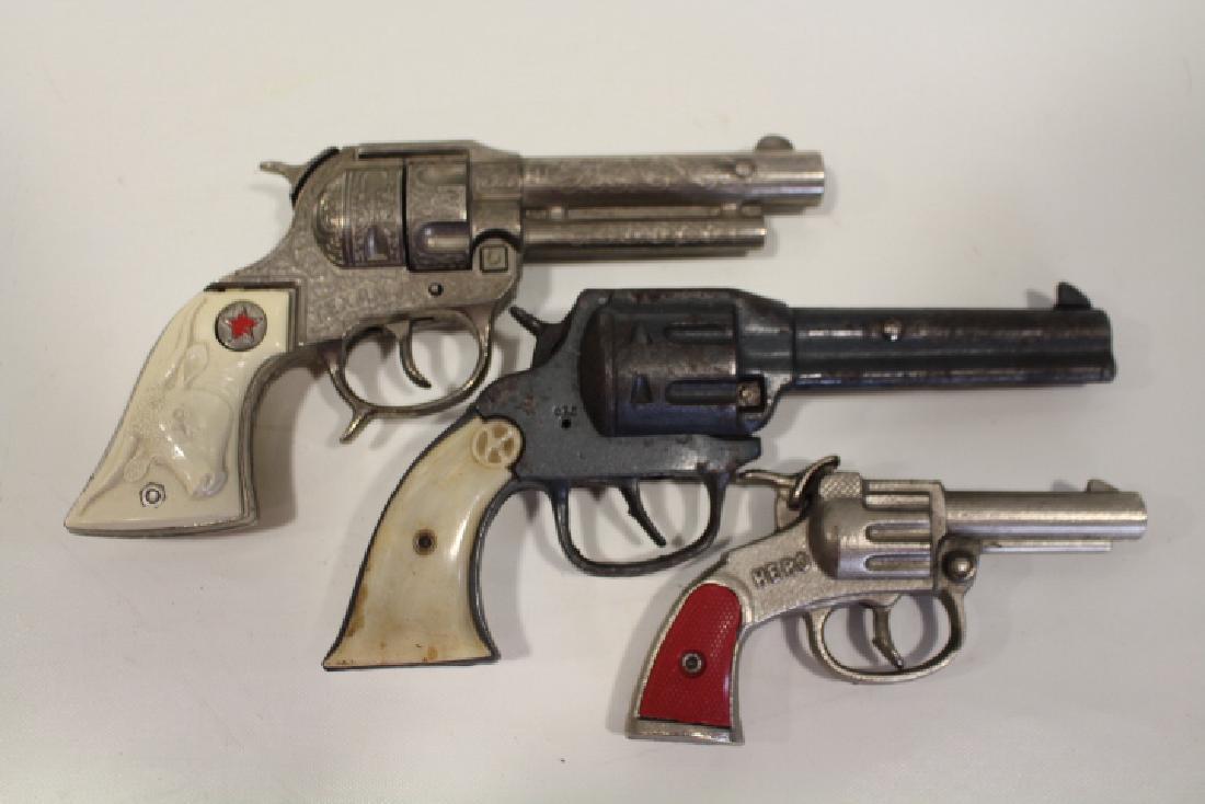Lot of 3 1930-50s Cap Guns: Lot of 3 1930-50s cap guns - Texan Jr., short barrel, 8" L; Kilgore Hi-Ho with faux mother of pearl handle covers, 8" L; Hero with red handle cover, 5 1/2" L. All working.