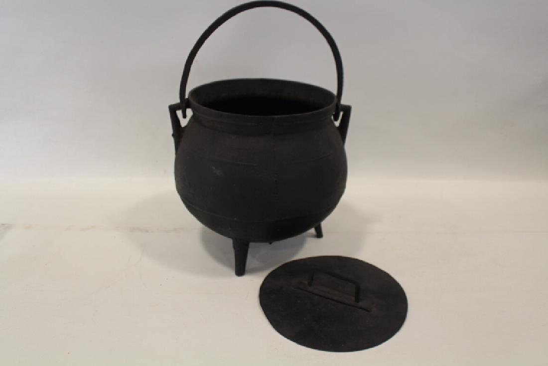 Early 19th C Cast Iron Hearth Cooking Posnet Pot & Lid: Early cast iron hearth cooking posnet pot with lid and swing handle, 9 3/4" H plus handle.