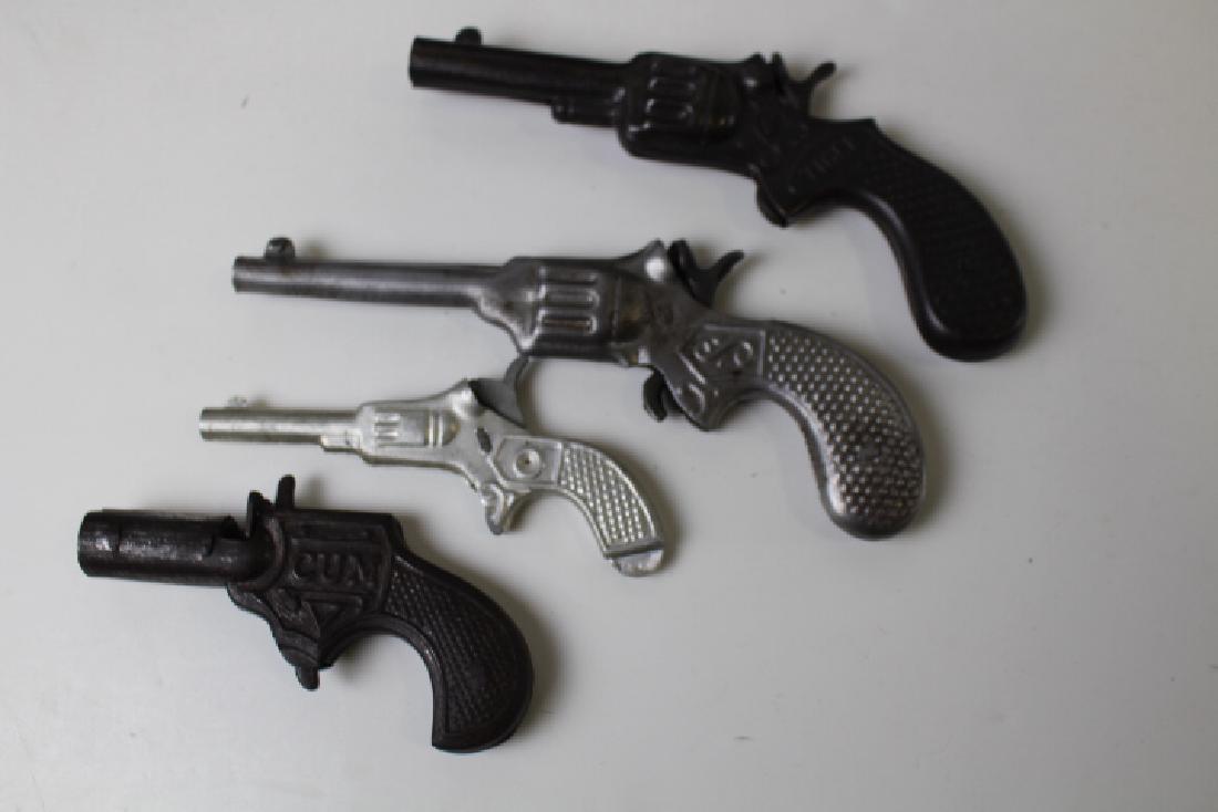 Group of 4 Toy Tin Cap Guns: 19th to early 20th century lot of 4 tin toy cap guns - longest marked 885, cock trigger, 7" L; "Tiger" cock trigger, 6 1/4" L; marked DRGM cock trigger with tiny hole in barrel shoots a projectile?, 4