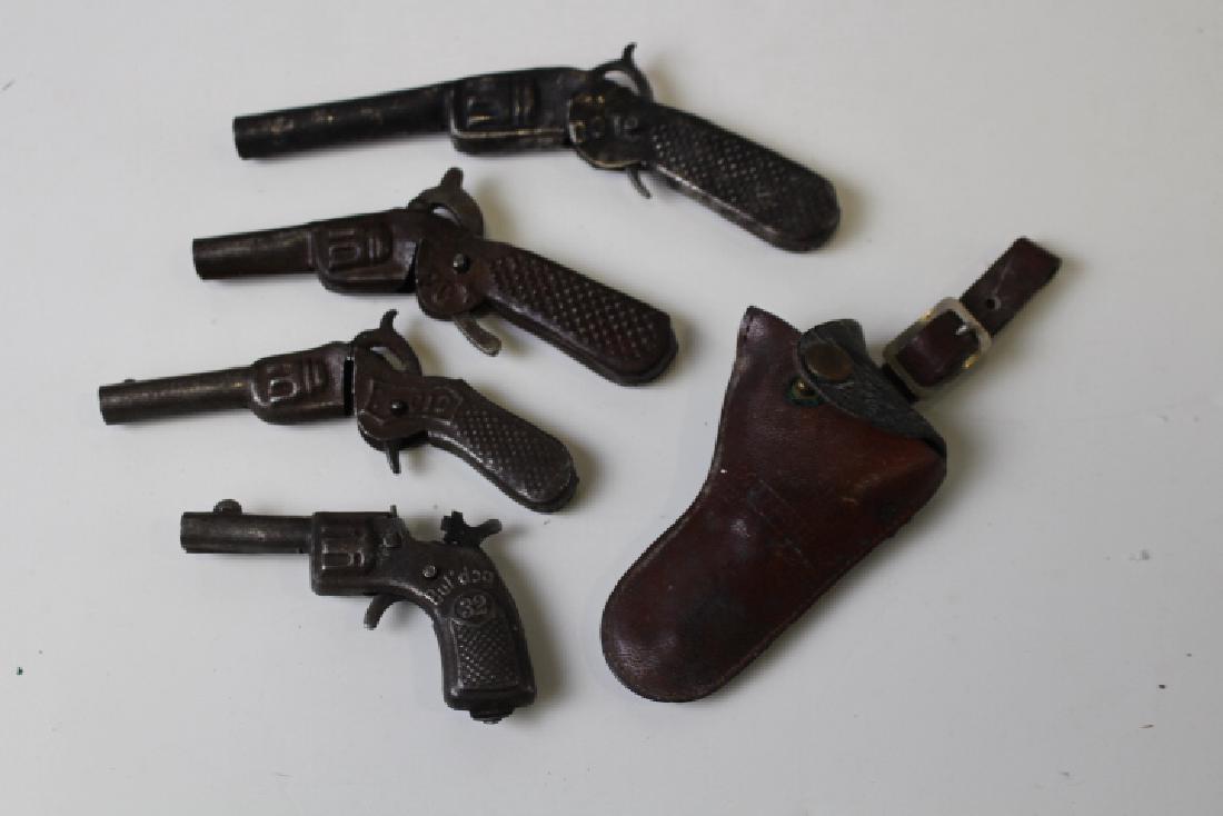 Lot of 4 Early 20th C Tiny Tin Cap Guns & Holster: Lot of 4 plus holster 19th to early 20th century tiny tin cap guns - smallest marked "Bul-Dog 32 Made in Germany" with holster, 3" L; one marked Fox; another marked CID; last marked "RMC DOT".