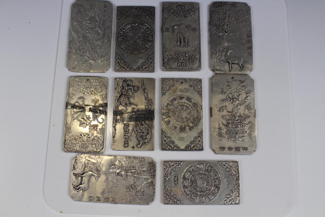 Chinese Calendar Plaques: Group of ten Chinese calendar plaques, embossed with animals, Zodiac, Oriental scenes, tallest 4" H. Silver content untested / unknown. In-house shipping available on this lot.