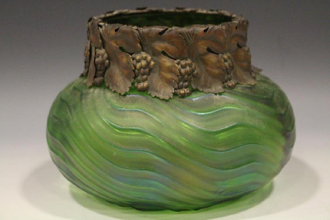 Loetz Green Low Bowl Metal Collar Grape Leave Clusters: Art glass attributed to Loetz, green iridescent low bowl with a pulled geometric ribbed pattern, collar of thin gilt-metal grape leaves and clusters hanging around the rim, 5 1/4" H x 7" W. Excellent