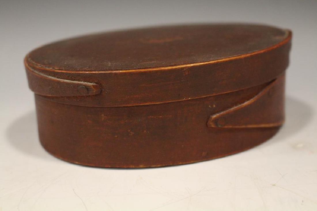 Small Red Stained Pantry Box - Single Finger Laps: Small size oval pantry box, original red stain, single finger laps on lid and base, 5" L x 3 3/4" D x 1 1/2" H. Very good condition.
