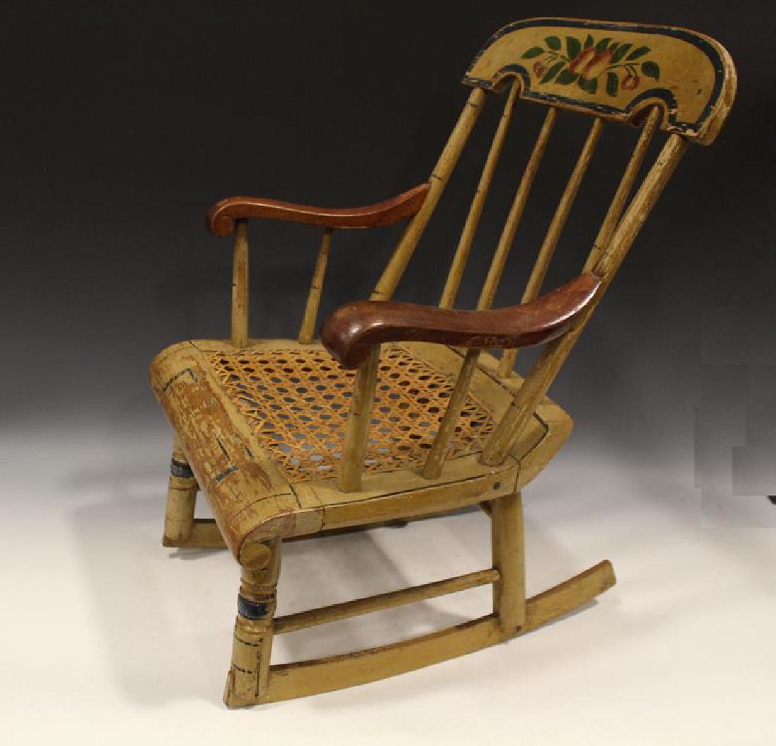 19th C. Childs Mustard Painted & Paint Decorated Rocker: Mid-19th C. child's mustard painted and paint decorated plank bottom seat rocker with hole caned seat, spindle back, rug cutter rockers, 20" H.