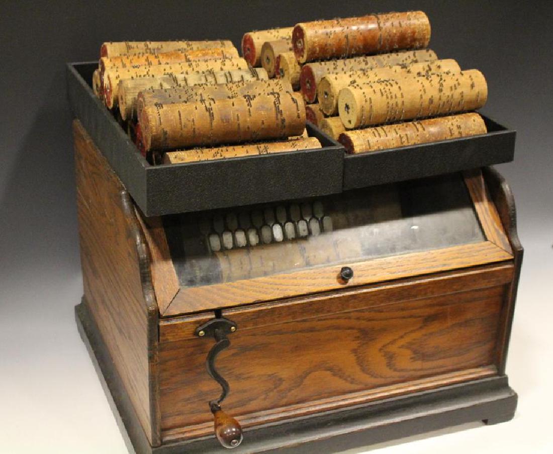 Ca. 1880s Concert Roller Organ w/ 27 Roller Cobs: 1880-90s roller organ, oak cabinet, 27 roller cobs, 17" x 12" H x 15" D. Handle must be turned rapidly to get a tune. Some of the labels were readable or partially readable: No. 65 What a Friend We Ha