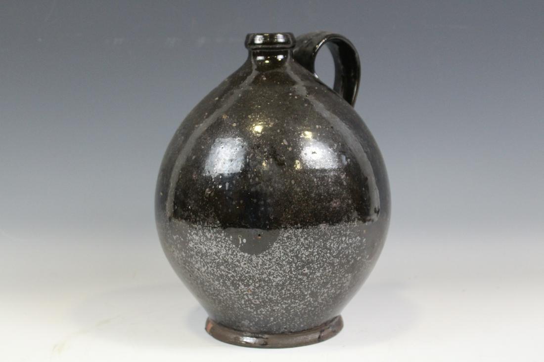 Early 19th C. Redware Jug: 1800-1820 redware ovoid jug, strap handle, 11" H. Small surface flake at base foot.