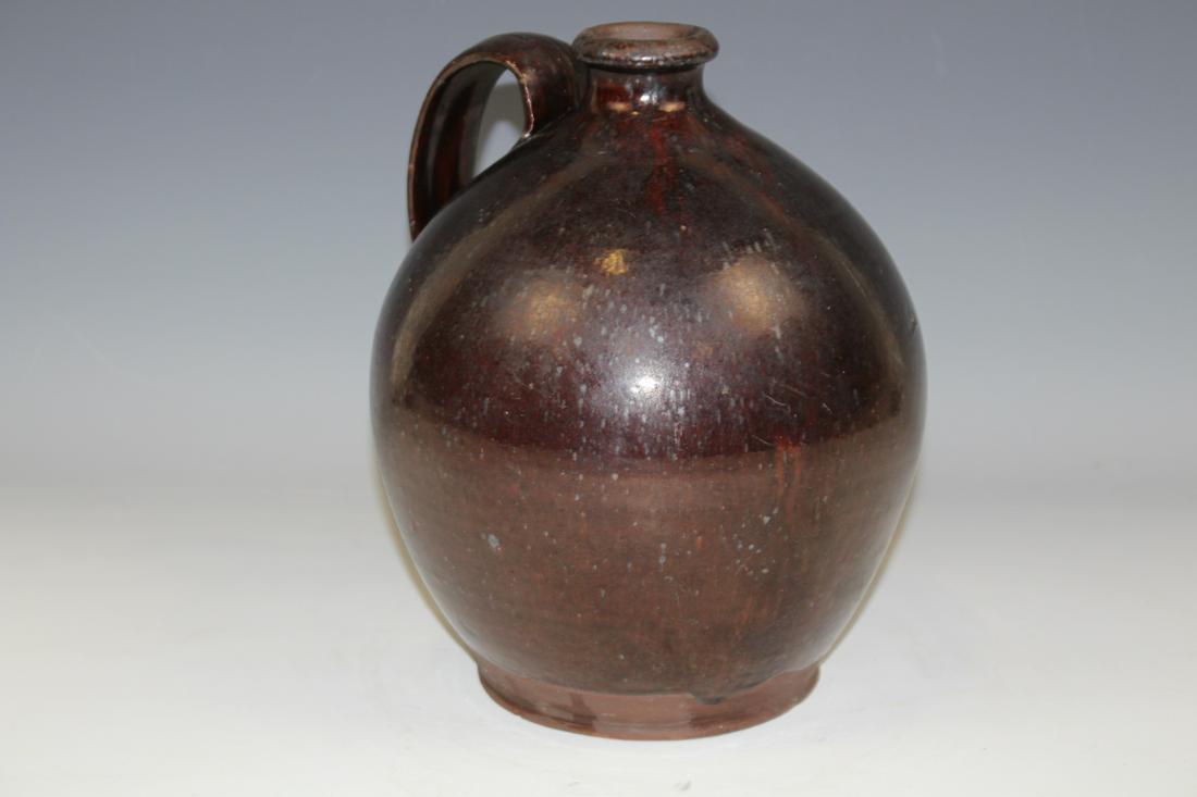 Early 19th C. Redware Jug w/ Strap Handle: 1800-1820 redware ovoid jug, strap handle, round, protruding lip, 10 1/4" H. Small surface flake at base foot.