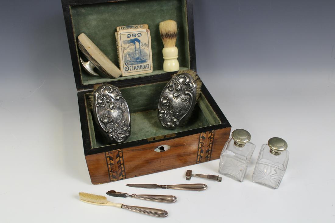 Inlaid Wooden Travel Box Sterling Contents: Inlaid walnut / wooden velvet lined travel box with sliding tray, contents: sterling silver items - 2 glass bottles with screw caps, matching set of toothbrush, 2 nail tools and nail buffer; assembled