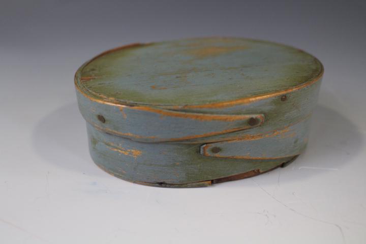 Small Blue Painted Oval Pantry Box: Small Blue Painted Oval Pantry Box - 4 3/4" W x 3 1/2" D x 1 1/2" H. Expected paint rubs and some light chipping to bottom front - see photo close-up.