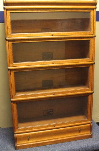 Globe-Wernicke Oak 4-Stack Bookcase + Drawer: Labeled Globe-Wernicke golden oak 4-stack bookcase with lower drawer, 58" H x 34" W x 12 1/2" D. No issues noted. THIS LOT REQUIRES A THIRD PARTY PACKER AND SHIPPER. LOCAL PICK-UP AVAILABLE BY APPOINT