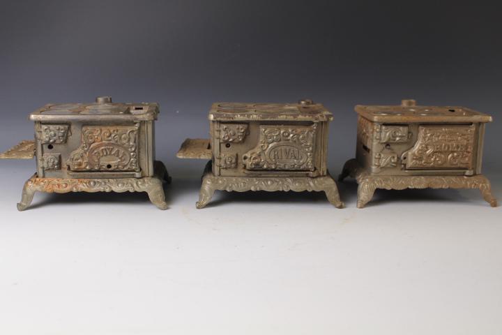 Lot of 3 Cast Iron Children's Toy Stoves: Lot of 3 Cast Iron Children's Toy Stoves - each has four burner covers, most being replacements, each 7 1/2" W.