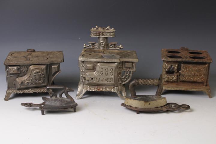 Lot of 3 Cast Iron Children's Toy Stoves & Irons: Lot of 3 Cast Iron Children's Miniature Toy Stoves - incomplete; 2 cast iron toy irons (one swan form) and trivets, largest 6" W.