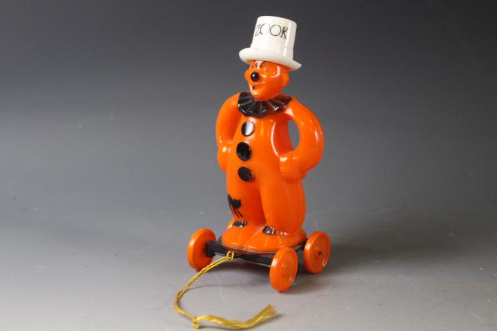1950's Halloween Rosbro Plastic Zook the Clown: 1950's Halloween Rosbro Hard Plastic Zook the Clown on Wheels Pull Toy - original tasseled pull string, 6 1/4" H. MORE OF THIS LARGE HALLOWEEN COLLECTION IN THIS SALE - SELLING THROUGHOUT AUCTION INCL