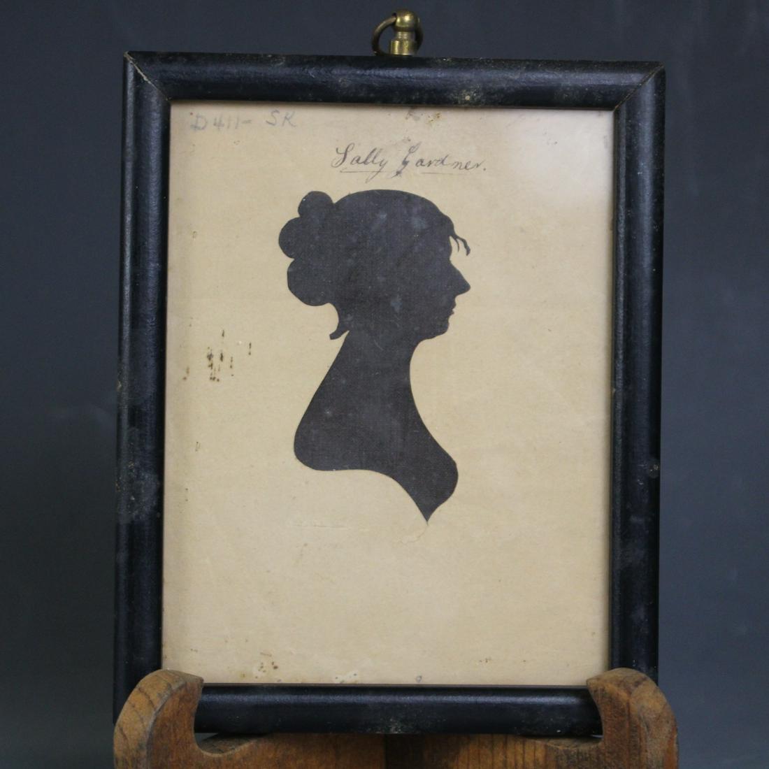 William King Portrait Silhouette of Sally Gardner: William King, Cutter, Portrait Silhouette of Sally Gardner - paper over fabric hollowcut, bust-length portrait in profile, facing left, backing with paper label "John M Wiseman, Gilder and Picture Fra
