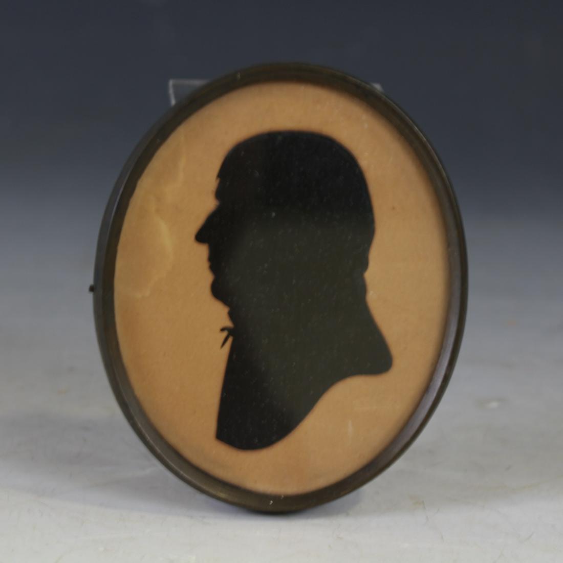 Cutter William King, 1785-1809, Male Silhouette: Signed King, Active 1785-1809, Hollowcut Male Sitter's Silhouette, embossed "King" just under sitter's right shoulder, unusual beveled solid wood backing set in 4" H oval, metal frame. Note - Approxim
