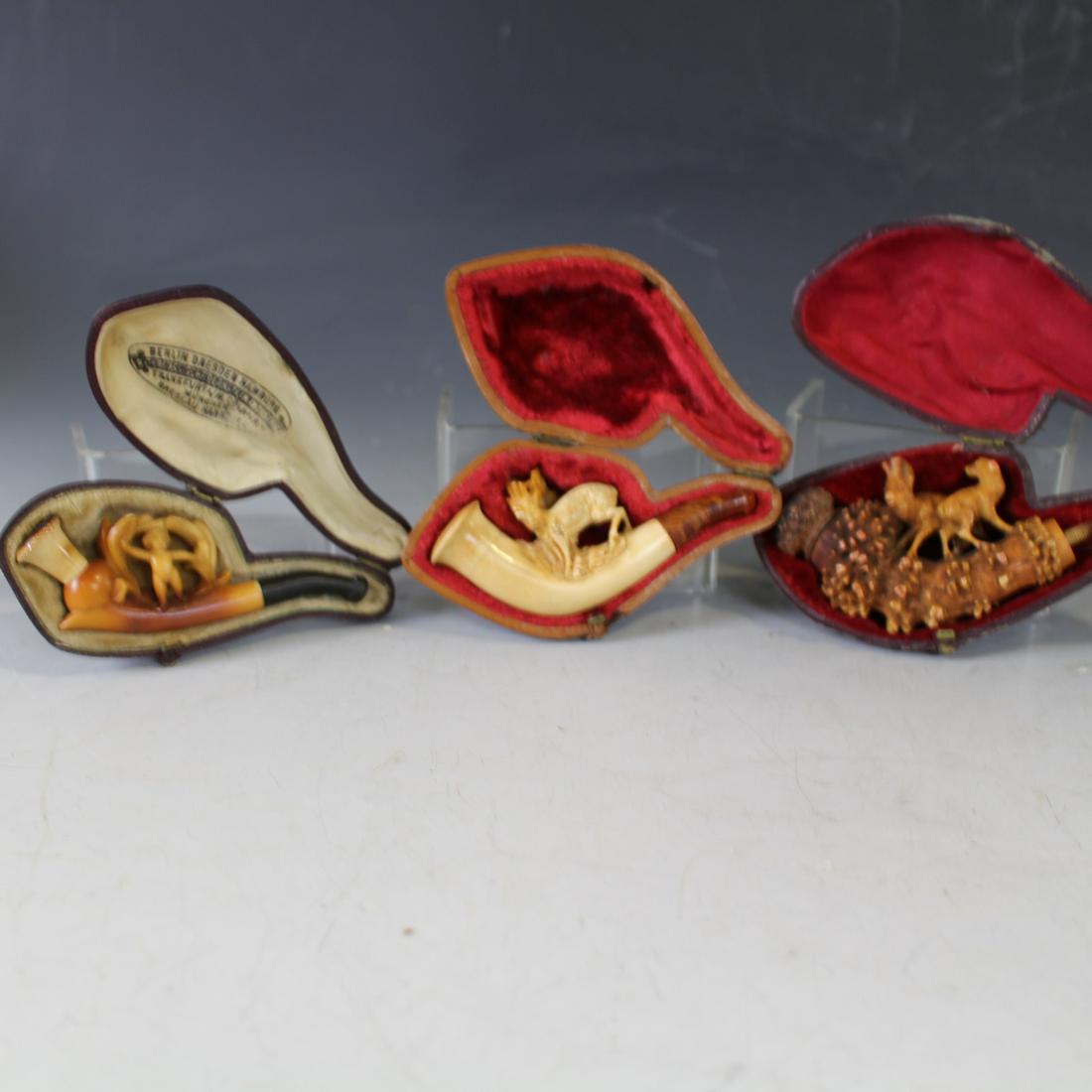 Meerschaum Pipes Stag, Nude Baby, Doe & Fawn: Meerschaum Pipes Stag, Nude Baby, Doe & Fawn in Fitted Cases - 1) Doe & fawn, carved tree stump, lacking end; 2) stag with very large antlers; 3) nude baby, 3 1/2" L, few tips missing.