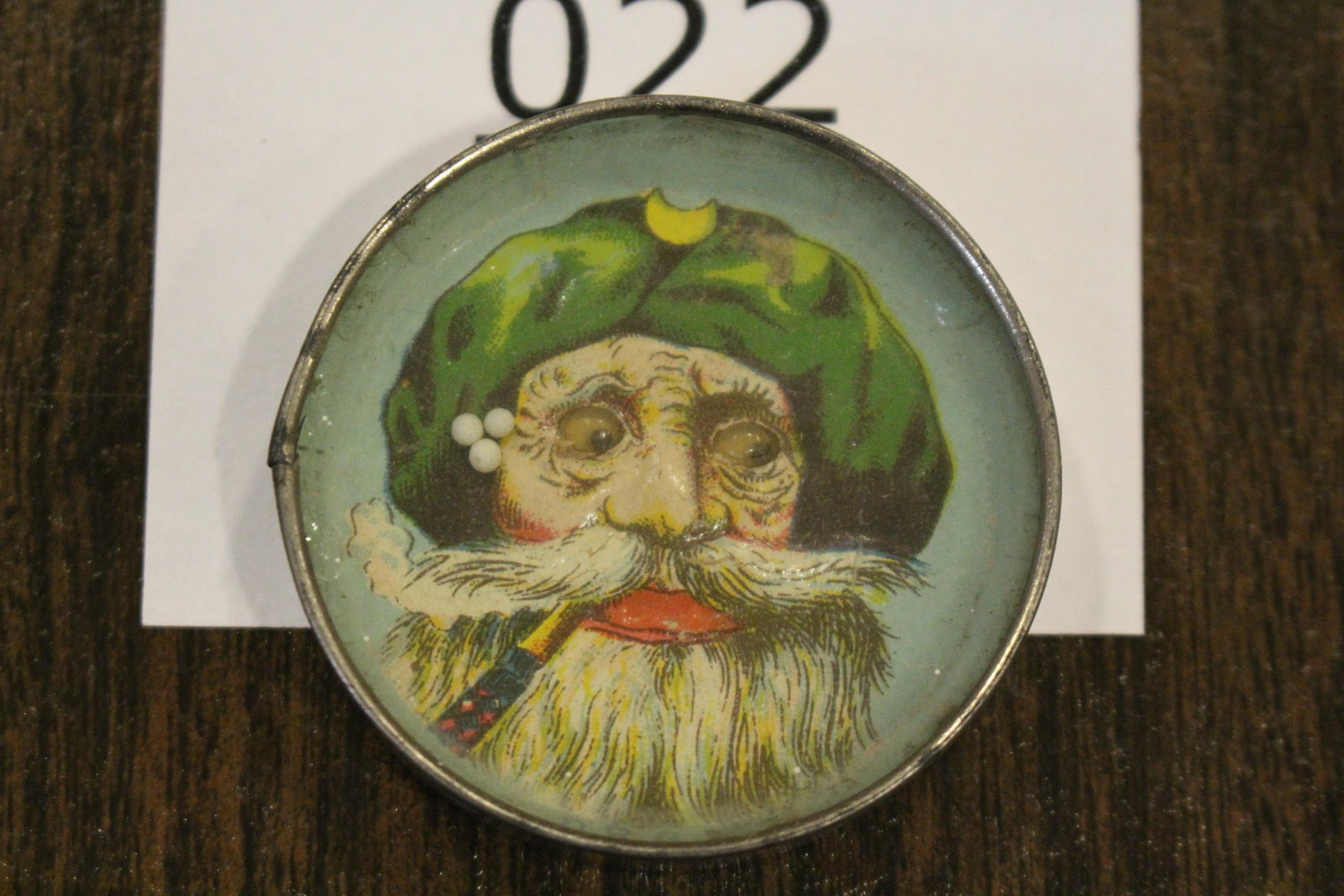 Embossed Elderly Gentleman Dexterity Game: Dexterity game / handheld puzzle game with metal highly embossed image of Arabian or Mediterranean man with turban, sporting a large mustache and beard, smoking pipe, mirrored back, 2" W. Good.