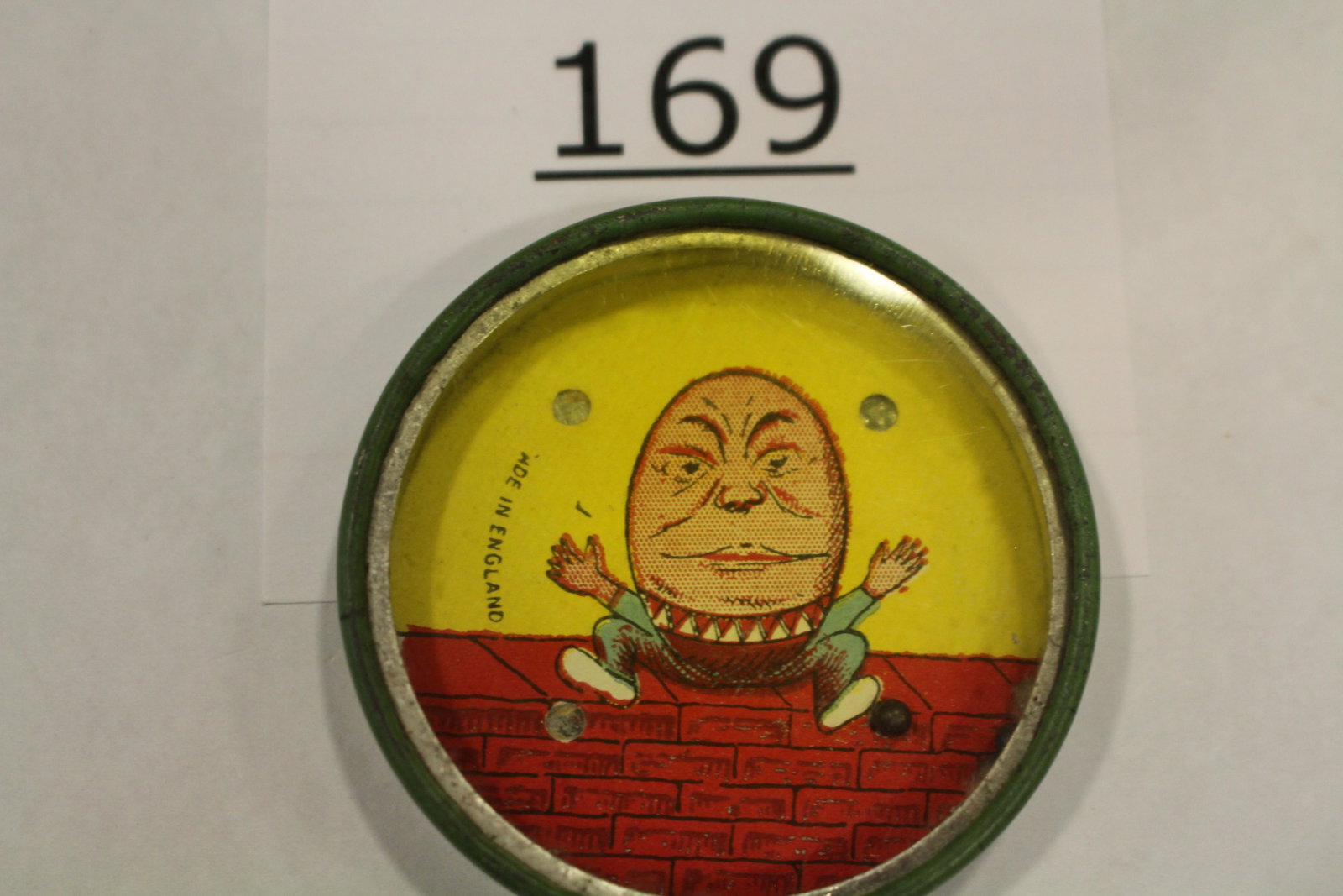 Humpty Dumpty Dexterity Game: Dexterity game / handheld puzzle game with image of Humpty Dumpty sitting on a wall, "Made in England", all metal, 2" W. Good.