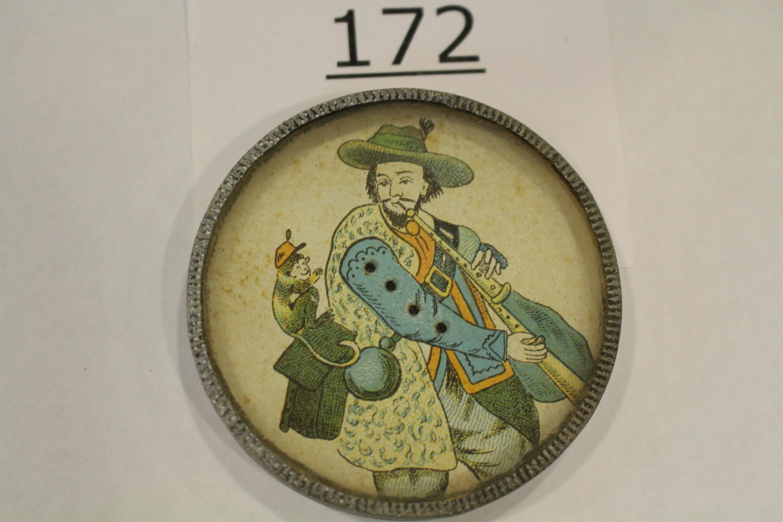 Cavalier Man & His Monkey Dexterity Game: Dexterity game / handheld puzzle game with image of a Cavalier man with his monkey, metal frame, mirrored back, 2 1/4" W. Good.