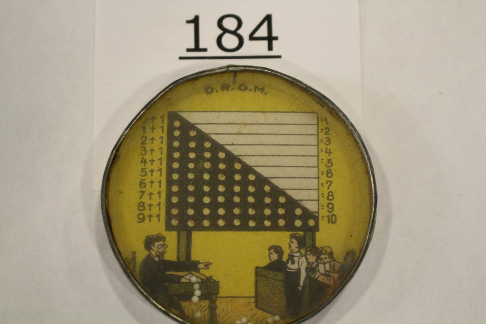 School Teacher & His Students Dexterity Game: Dexterity game / handheld puzzle game with image of a classroom with teacher, students and a math chart, metal frame, mirrored back, 2 1/4" W. Good.