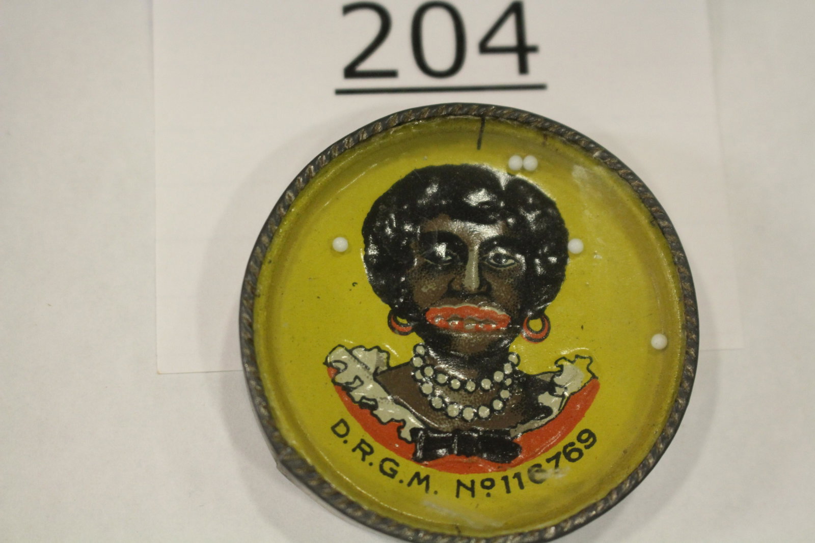 Black Americana Woman Dexterity Game: Dexterity game / handheld puzzle game with image of a black woman, all metal, 1 3/4" W. Good.