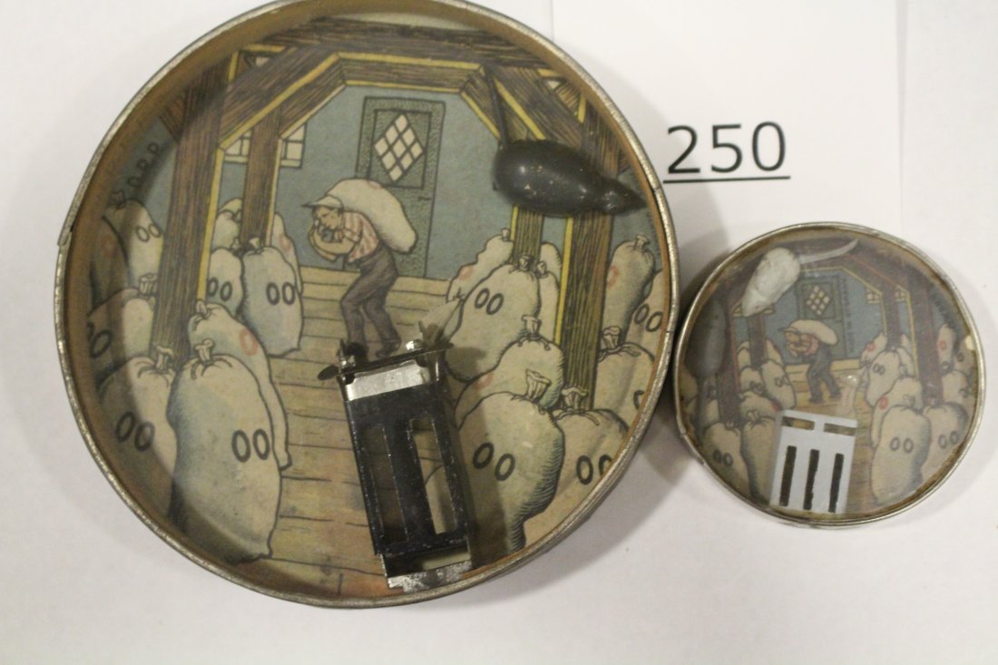 Mice in Grain Mill Dexterity Games Large & Small: Dexterity games / handheld puzzle games both with an image of a grain mill's interior showing bags of grain, both with hard challenges: 1) get the pair of full-bodied, one white and one gray, mice int