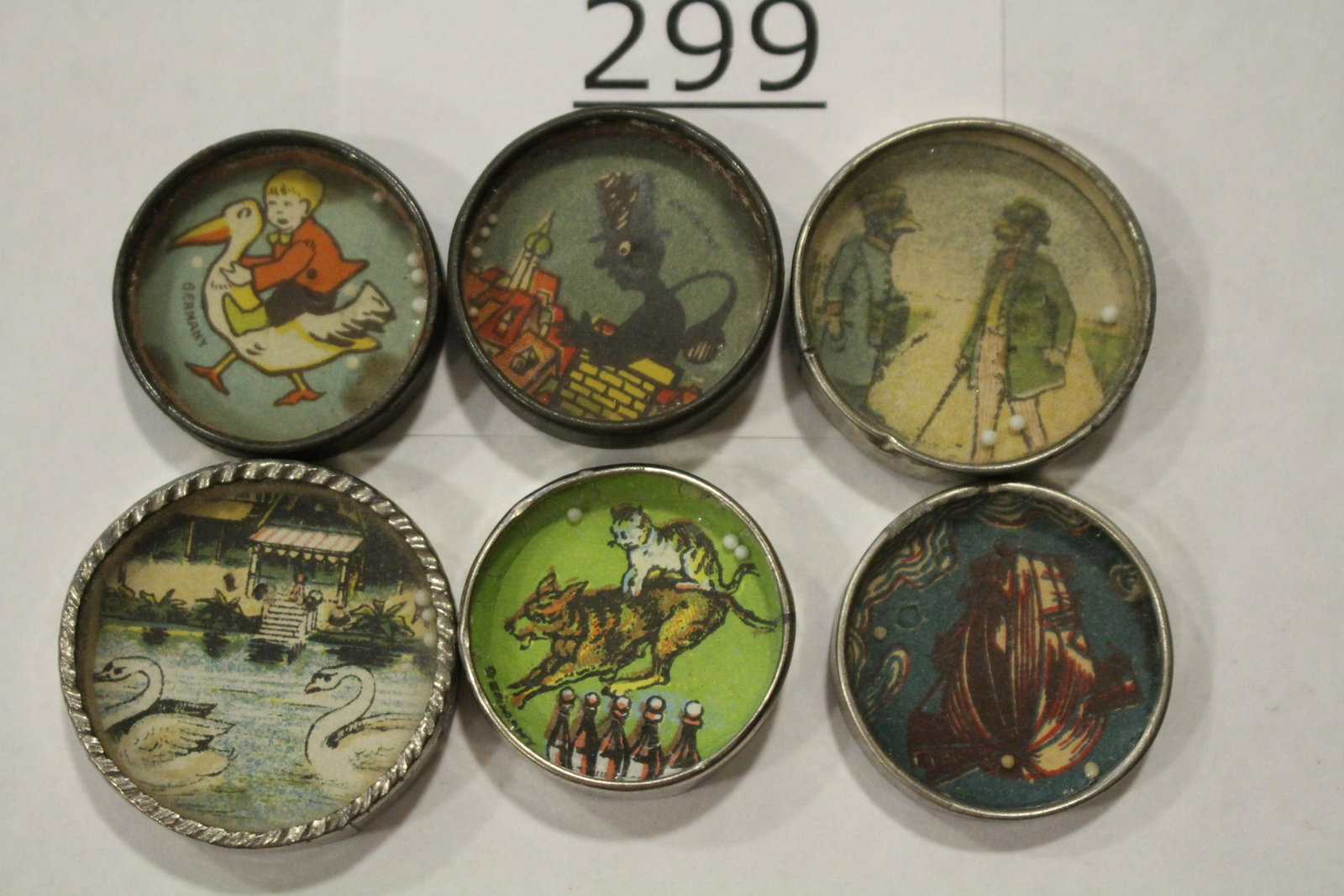 Lot of 6 Small Dexterity Games: Lot of 6 dexterity games / handheld puzzle games with various images to include a frog, swans, chimney sweep, cats, boy riding goose, Anthropomorphism birds, largest 1 1/4" W. Good.