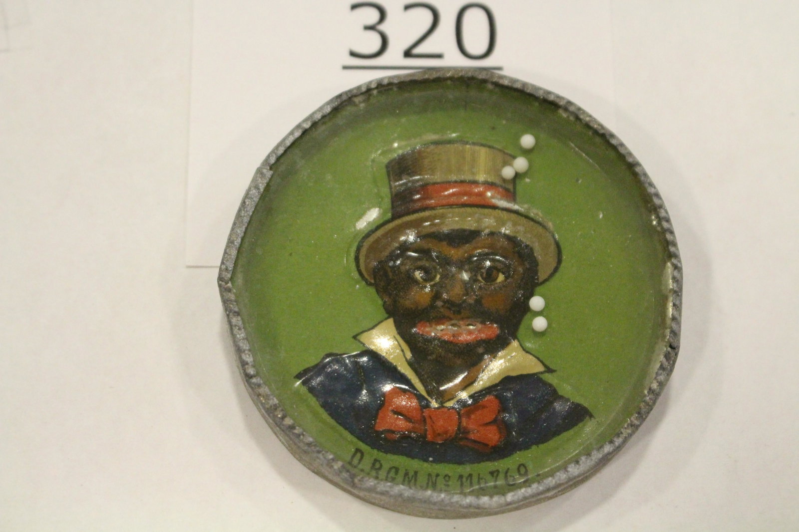 1901 Advertising Black Americana Dexterity Game: Advertising Dry Good and Millinery dexterity game / handheld puzzle games with an embossed image of a black man in fancy attire, labeled back "OPENING SALE FEB 1901 DRY GOODS AND MILLINERY S.E. EIGHME