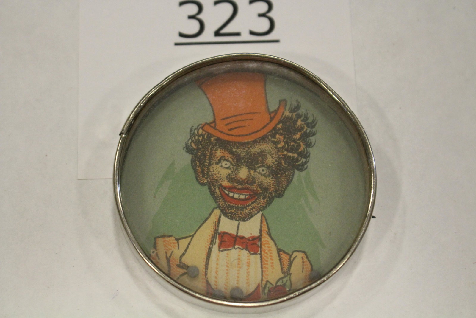 Black Man Dandily Dressed Dexterity Game: Dexterity game / handheld puzzle game with image of dandily-dressed man in fancy yellow suite with red top hat, metal frame, mirrored back, 2 1/4" W. Good.
