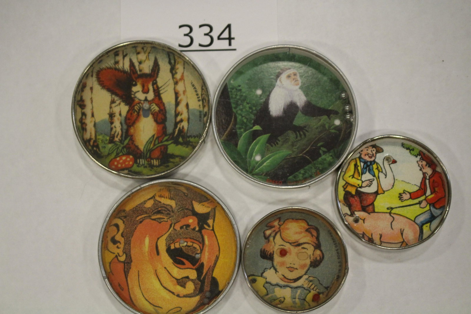 Group of 5 Dexterity Games: Group of 5 misc. dexterity games / handheld puzzle games, metal frames, cardboard backs, (laughing man with French ad on back side), largest 2 1/4" W. All good.