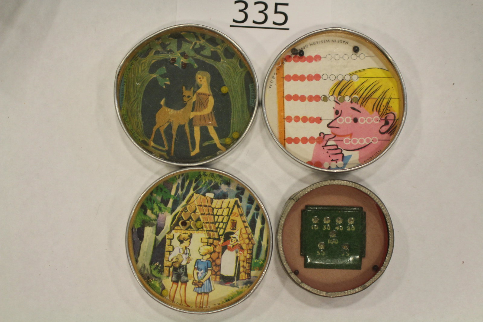 Group of 4 Misc Dexterity Games: Group of 4 dexterity games / handheld puzzle games with images of boy pondering an abacus; green metal scoreboard; Hansel and Gretel scene; girl with fawn, each with metal frame and mirrored back, lar