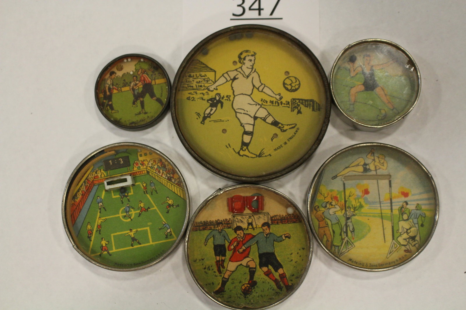 Sports-Themed Dexterity Games: Group of 6 sports-themed dexterity games / handheld puzzle games with metal frames - images of 1) soccer player, 2 3/4" W, only one with cardboard back others with mirrored backs; 2) view of soccer fi
