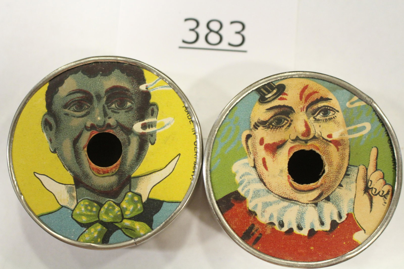 Man & Clown Cigarette Holder Dexterity Games: Lot of 2 dexterity games / handheld puzzle games / cigarette holders each with images as if blowing smoke rings, 1) clown; 2) black man, each with metal frame, cardboard front and back, and each has f