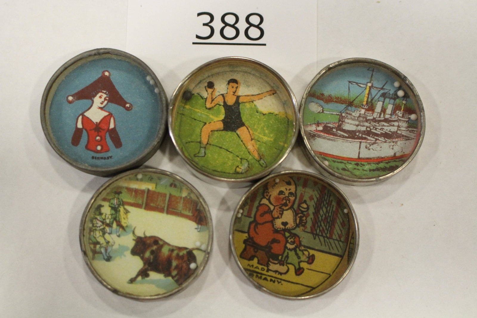 Group of 5 Dexterity Games: Group of 5 dexterity games / handheld puzzle games with images of 1) pole-vaulter; 2) lady with tri-corner hat; 3) war ship; 4) baby with rattle; 5) bull and toreadors; metal frames, two with mirrored