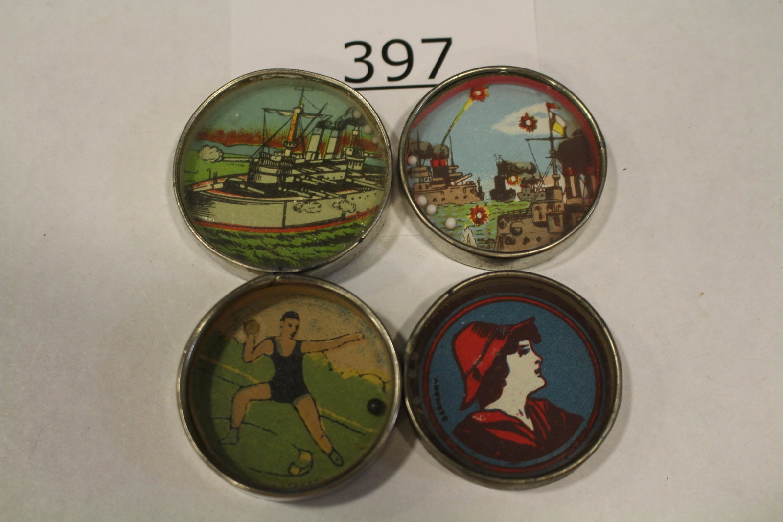 Lot of 4 Dexterity Games - Including 2 Ships: Dexterity games / handheld puzzle games with images of 1) large ship shooting guns; 2) group of ships shooting guns; 3) Robin Hood-type boy; 4) shot put athlete; metal frames, 1 with mirrored back, 1 
