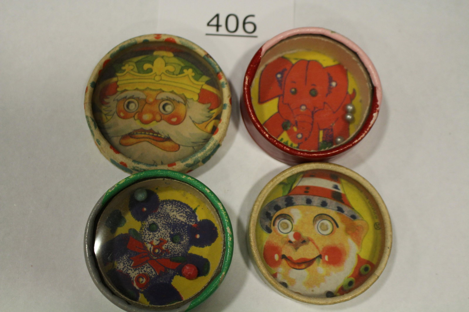 Lot of 4 Dexterity Games - Red Elephant, Others: Lot of 4 dexterity games / handheld puzzle games with images of a king; alpine man; red elephant; black teddy bear; all cardboard construction, two with glass covers, 2 1/2" W. Good.